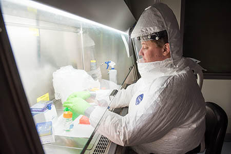 Researcher works in a training lab in the Biosecurity Research Institute